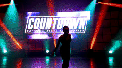 COUNTDOWN competition stage with dancer performing under arena lights