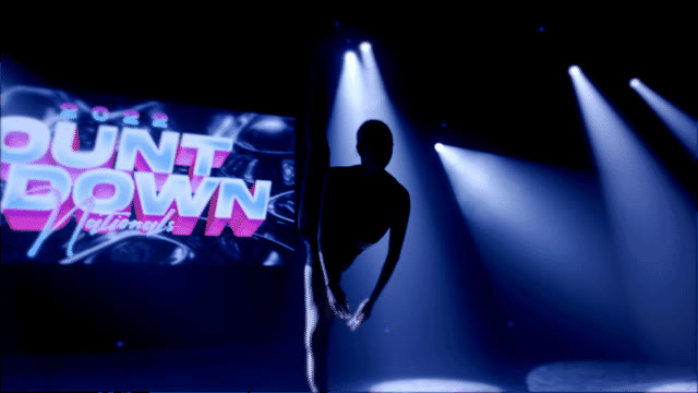 Dancer silhouetted on the COUNTDOWN Nationals stage under spotlights